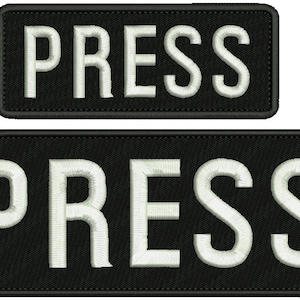 May include: Two black rectangular patches with white embroidered text that reads "PRESS".