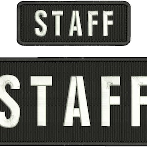 May include: Two black rectangular patches with white text that reads "STAFF" in all capital letters. The top patch is smaller than the bottom patch.