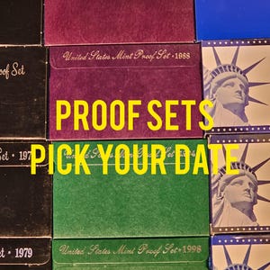 May include: A collection of United States Mint Proof Sets in various colors, including burgundy, green, and blue. The text "PROOF SETS PICK YOUR DATE" is displayed in yellow. The sets are from 1979, 1984, 1988, and 1998.