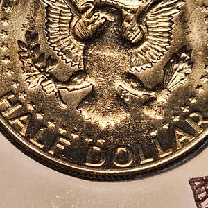 May include: A set of three ceramic mugs with a speckled, matte finish. The mugs are in shades of cream, light gray, and dark gray. Each mug has a simple, minimalist design, perfect for coffee or tea.