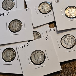May include: A collection of silver coins on white card stock with the dates 1929, 1930, 1931, and the mint marks S and D.