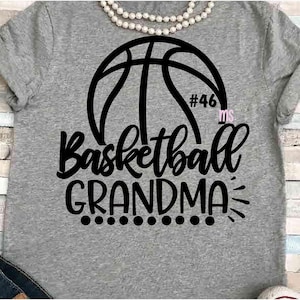 May include: Gray t-shirt with a black basketball graphic and the text "Basketball Grandma" with a number 46 and the word "Ms." in pink.