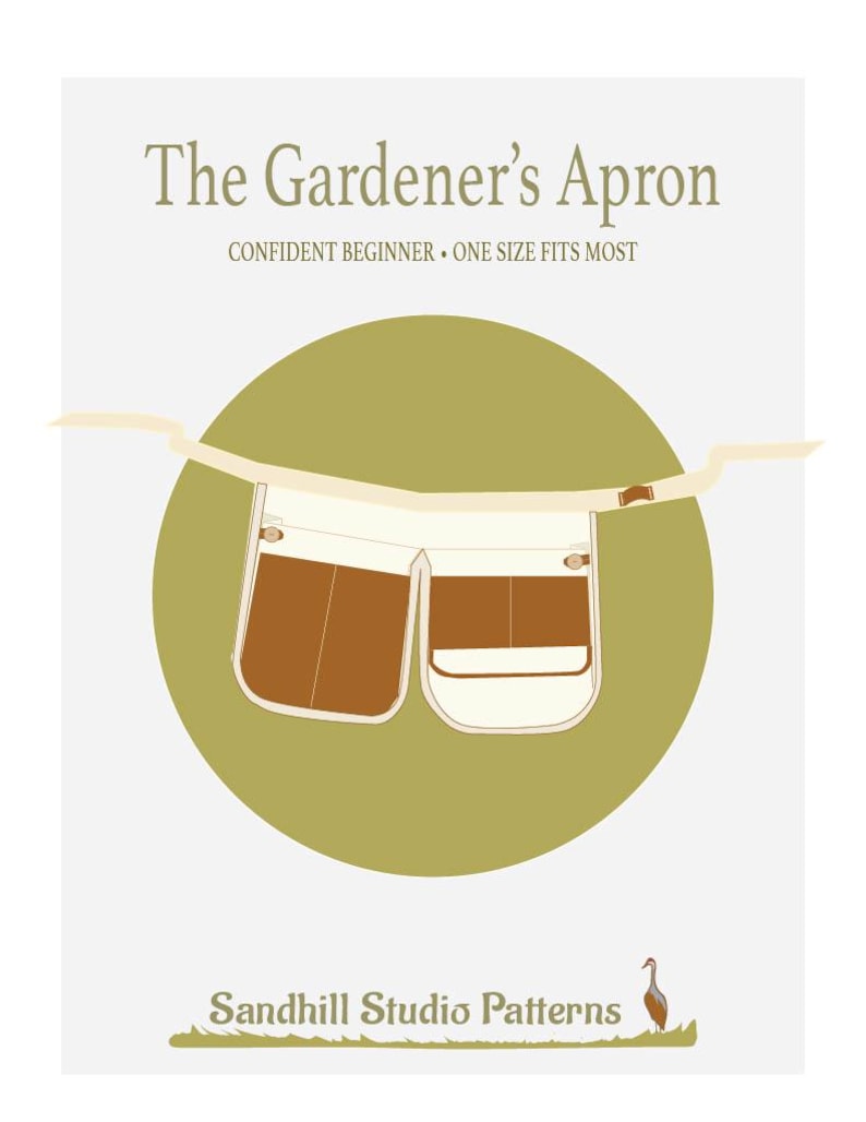 May include: A digital illustration of a gardener's apron with two large pockets. The apron is white with brown pockets and is hanging from a brown strap. The apron is on a green circle with the text "The Gardener's Apron" and "Confident Beginner - One Size Fits Most" above the apron. The text "Sandhill Studio Patterns" is below the apron with a small illustration of a bird.