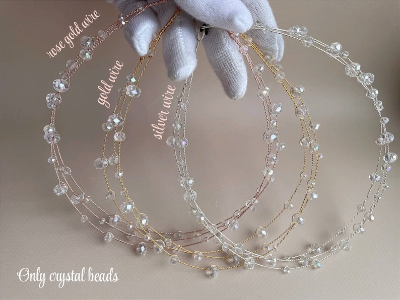 May include: Three crystal bead headbands in rose gold, gold, and silver wire.  The headbands are made with clear crystal beads and are shown on a white surface.  Only crystal beads.