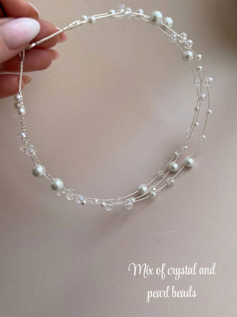 May include: A delicate silver headband with a mix of crystal and pearl beads. The headband is made of thin wire and has a circular shape.