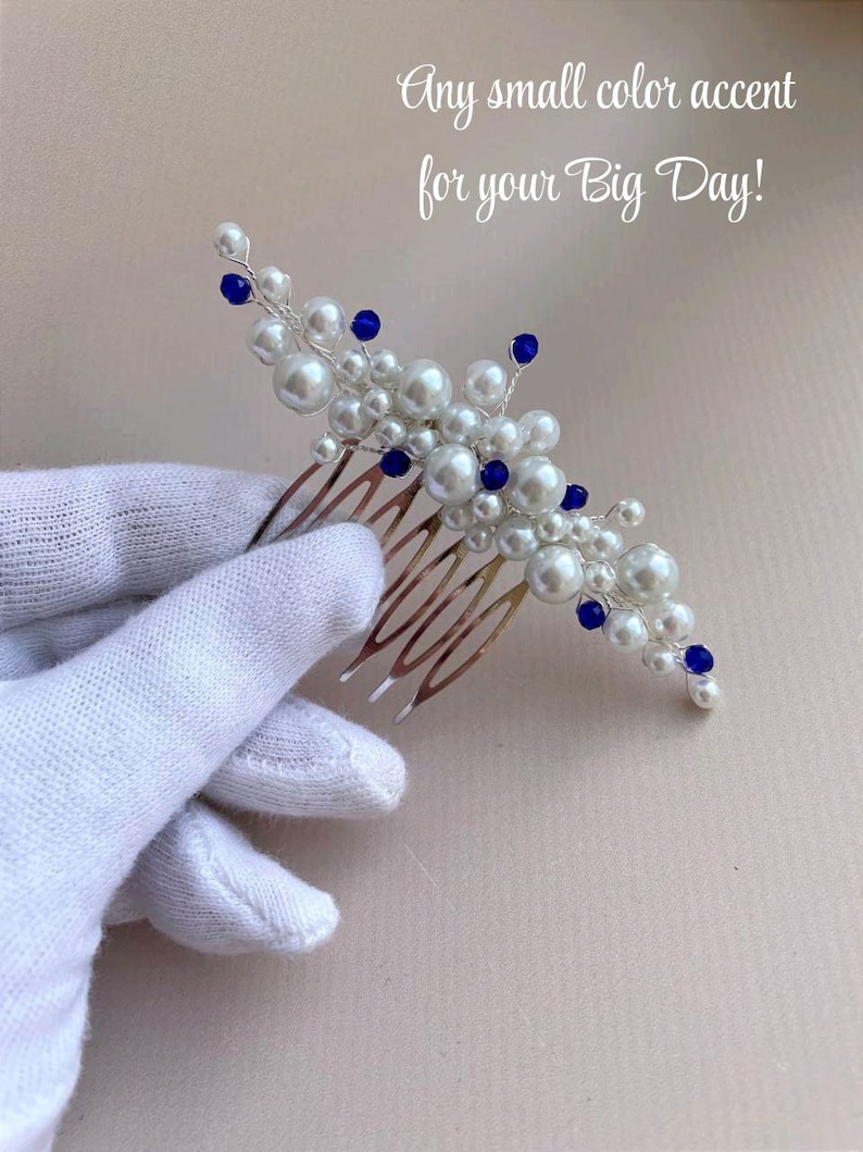 May include: A bridal hair comb featuring white faux pearls and blue accents. The comb has a silver-tone metal base and is adorned with various sizes of pearls and blue beads. Text on the image reads: "Any small color accent for your Big Day!"