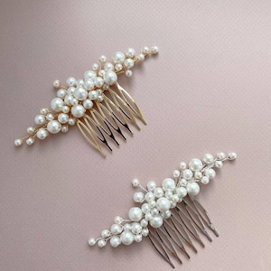 May include: Two hair combs with pearl accents. One comb has a gold finish, the other a silver finish. Both combs feature clusters of white pearls of varying sizes, arranged on a comb base for easy styling.