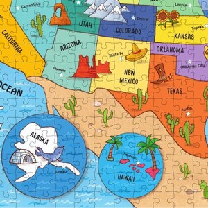 May include: A colorful illustrated map of the United States with each state labeled. The map includes Alaska and Hawaii as separate insets. The map is made up of puzzle pieces.
