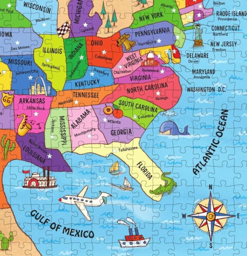 May include: A colorful map of the United States with each state outlined in a different color. The map includes state names, major cities, and small illustrations of landmarks and animals. The map is surrounded by a blue ocean with a compass rose in the bottom right corner.