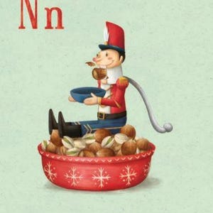 May include: A red and blue nutcracker doll sits on a red bowl filled with nuts. The doll is holding a bowl and has a long, white tail. The text "Nn" and "Nutcracker" are printed below the image.