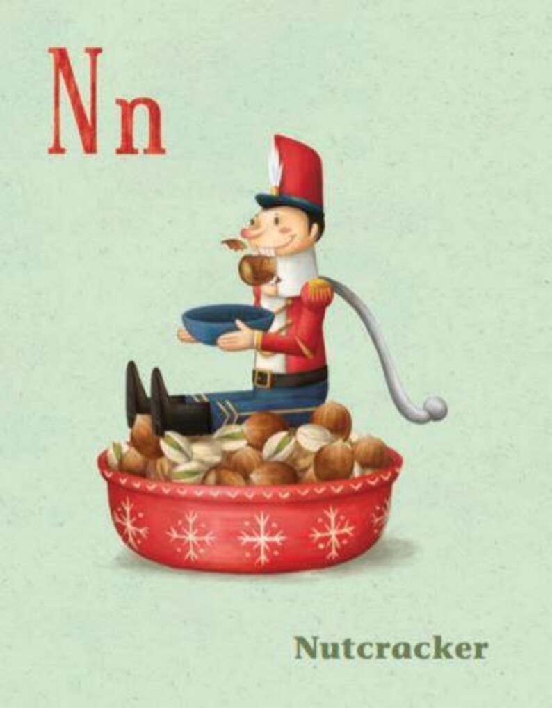 May include: A red and blue nutcracker doll sits on a red bowl filled with nuts. The doll is holding a bowl and has a long, white tail. The text "Nn" and "Nutcracker" are printed below the image.