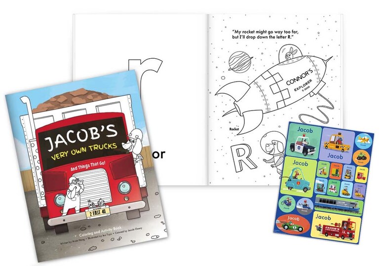 May include: A coloring and activity book for children featuring a red dump truck with the text "Jacob's Very Own Trucks" and a rocket ship with the text "Connor's Explorer". The book includes stickers with the name "Jacob" and various vehicles.