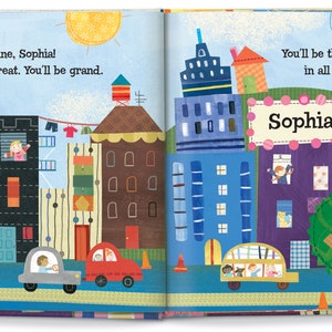 May include: A colorful illustrated book with a cityscape on the cover. The text on the cover reads "It's time to shine, Sophia! You'll be great. You'll be grand." and "You'll be the best big sister in all of the land! Sophia".