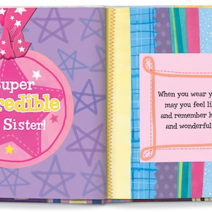 May include: A pink and yellow star-shaped award with the text "Super Incredible Big Sister!" on a purple background with pink stars.