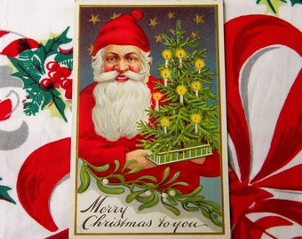 Antique Embossed Christmas Postcard - Santa Holding a Tiny Christmas Tree - Glowing Candles Mistletoe - circa 1910's