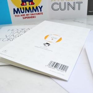 May include: A white card with a yellow circle and a black monkey illustration. The text "Thank you for making me a mummy" is printed on a white tag inside the circle. The text "Tehe" and a website address are printed below the monkey. A barcode is printed at the bottom of the card.