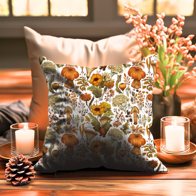 This square pillow features an assortment of forest fungi in shades of orange, yellow, and white with beautiful wildflowers and leaves on a white background. Printed on both sides.