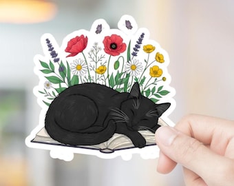 Adesivo in vinile impermeabile floreale con gatto nero che dorme su un libro