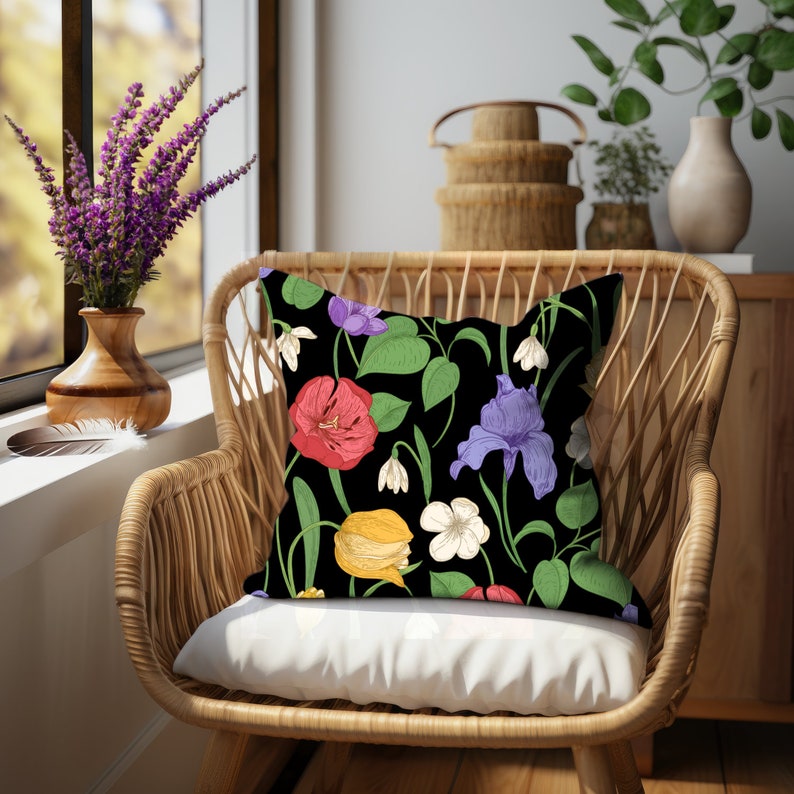 Square accent pillow with red peonies, purple irises, yellow tulips, white violets, and white snow drops on a black background