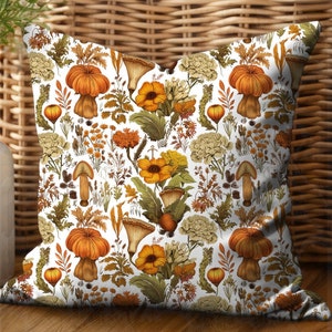 This square pillow features an assortment of forest fungi in shades of orange, yellow, and white with beautiful wildflowers and leaves on a white background. Printed on both sides.