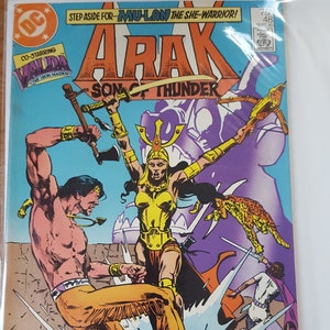 May include: A vintage comic book cover featuring the title "Arak, Son of Thunder." The cover art depicts a battle scene with multiple figures, including a warrior in gold armor and a shirtless man. The comic book is from DC Comics.