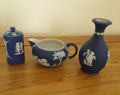Three Pieces of Wedgwood Dark Blue Jasperware including Cream Jug, Bud Vase, and Lidded Pot