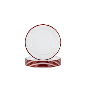 May include: A stack of six white enamel dinner plates with a red rim.