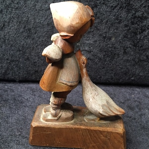 Antique delightful Black Forest Hand carved wooden Figure of a Young Swiss girl holding flowers