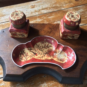 May include: Antique wooden inkwell set with two red and gold inkwells and a matching red and gold ceramic dish.