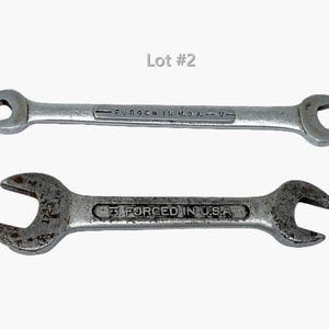 May include: Two silver-toned metal open-ended wrenches labeled Lot #2. The top wrench is smooth with the text FORGED IN U.S.A. V. The bottom wrench has a weathered, textured surface with the text 1723 and 3 FORCED IN U.S.A. stamped on it.