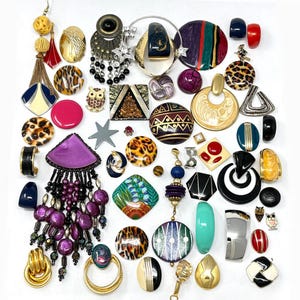 May include: A large collection of assorted vintage costume jewelry pieces, including various clip-on earrings, pins, and brooches in diverse shapes, colors, and patterns such as leopard print, geometric designs, and metallic gold and silver tones.