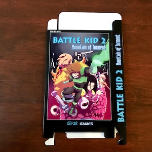 May include: A black box with a colourful illustration of a video game character on the front. The box is for the game "Battle Kid 2: Mountain of Torment" by Sivak Games.
