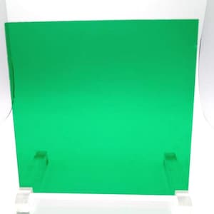 May include: A bright green sheet of acrylic plastic, supported by two white stands.