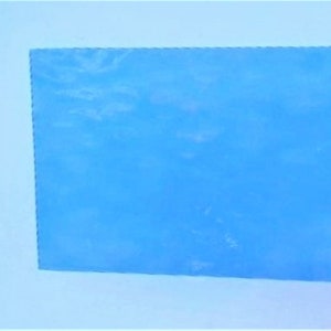 May include: A solid blue sheet of acrylic plastic. The plastic is smooth and has a slight sheen.