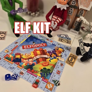 May include: An Elfopoly board game set featuring a colorful game board with Christmas gift illustrations, two blue dice, miniature game pieces, and play money. The text ELF KIT is displayed in large red letters over the board, with a toy elf figure.