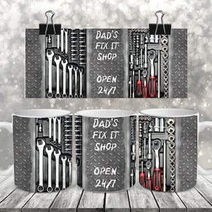 May include: White ceramic mug featuring a design of a toolbox filled with tools and the text "Dad's Fix It Shop Open 24/7".