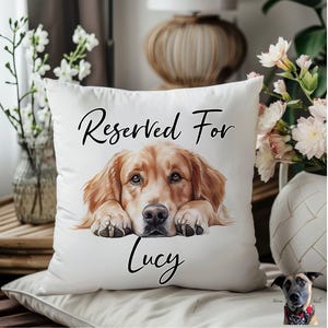 May include: White cushion with the text "Reserved For" and an illustration of a golden retriever dog. The dog's name, "Lucy", is written below the illustration.