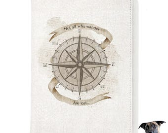 May include: A white leather journal cover with a vintage compass design and the quote "Not all who wander are lost..." printed on it.