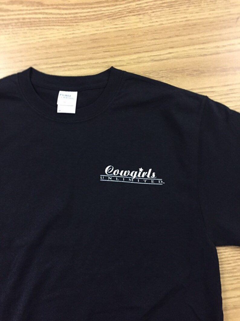 May include: Black t-shirt with a white graphic that says "Cowgirls Unlimited".