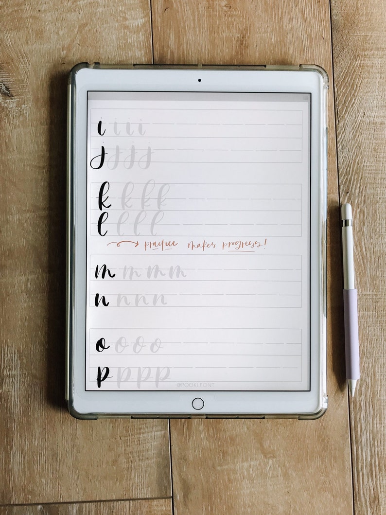 May include: A digital tablet screen displaying handwritten letters in black ink on a white background. The letters are 'i', 'j', 'k', 'l', 'm', 'n', 'o', and 'p'. The text "practice makes progress!" is written in red ink. The tablet is on a wooden surface.