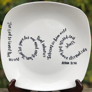 May include: White ceramic plate with a black cursive quote from the Bible, John 3:16, "For God so loved the world that whoever believes in him will not perish but have eternal life".