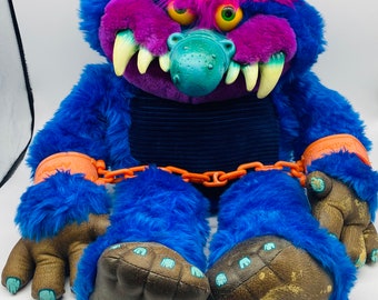 80s toy monster with handcuffs