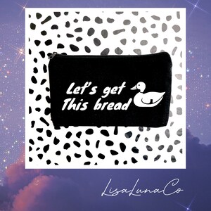 May include: Black canvas makeup bag with a white duck and the text "Let's get this bread".