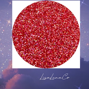 May include: A close-up of red glitter with a holographic finish. The glitter is in a circle shape and is against a white background.