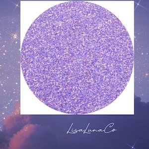 May include: A round, purple glitter eyeshadow with a white background and the text "lisaLunaCo" in a handwritten font.