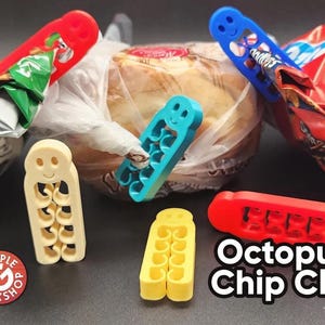 May include: A collection of colorful plastic Octopus Chip Clips in red, blue, yellow, and cream. The clips are designed to seal bags of chips and other snacks. The image also shows a loaf of bread and bags of chips.