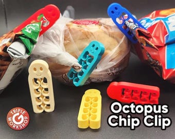 May include: A collection of colorful plastic Octopus Chip Clips in red, blue, yellow, and cream. The clips are designed to seal bags of chips and other snacks. The image also shows a loaf of bread and bags of chips.