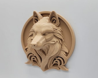 May include: A tan-colored wolf head sculpture with detailed fur and facial features. The wolf is set against a circular backdrop with decorative scrollwork at the bottom. The sculpture is likely made of a hard material.