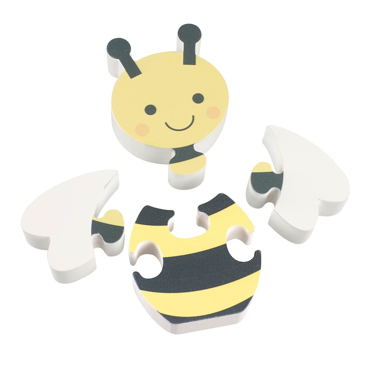 May include: A yellow and black bee puzzle with five pieces. The bee has a smiling face and black antennae. The puzzle pieces are made of foam.