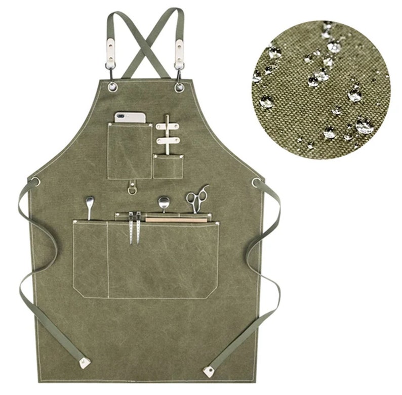 May include: A green canvas apron with multiple pockets and a cross-back strap design. The apron is water-resistant and has a variety of pockets for tools and supplies.